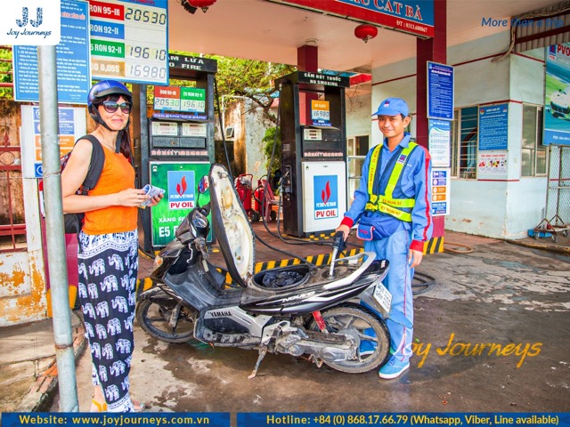 A woman is refueling the rented motorbike she is using for experience.
