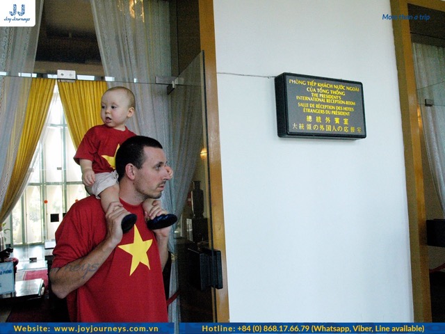 A father and his child are visiting Independence Palace and they look very cute.