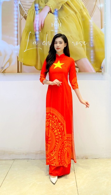 Modern red Áo dài with the printed red flag and yellow star of Vietnam.