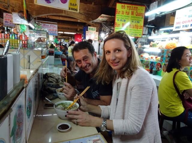 visitor and pho vietnam at ben thanh market