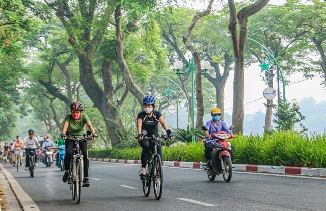 Cycling in the streets of Hanoi during autumn