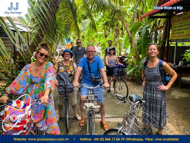 The group of tourists experiences biking in Ben Tre alongside Joy Journeys