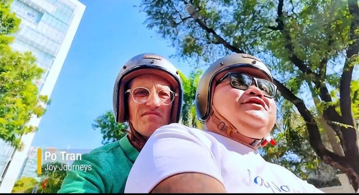 Richard Quest and his companion Po Tran on a motorbike ride in HCM city