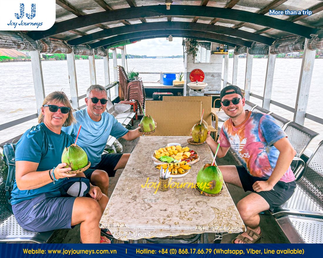 Tourists enjoy cool and sweet coconut water in Ben Tre